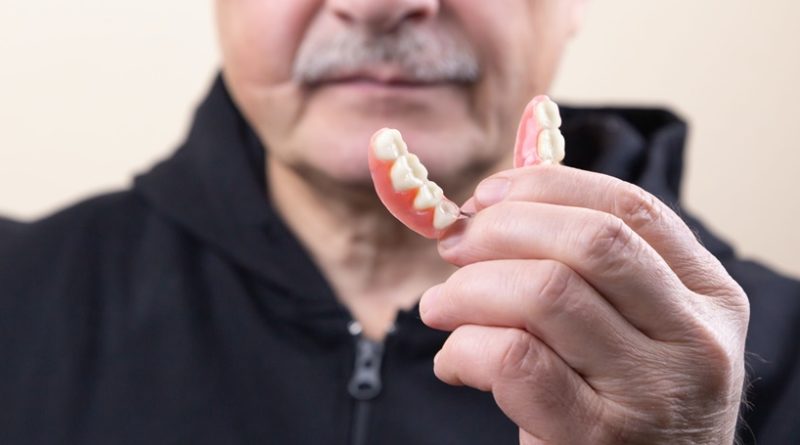 Why should you clean your dentures?